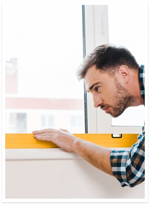 man measuring window